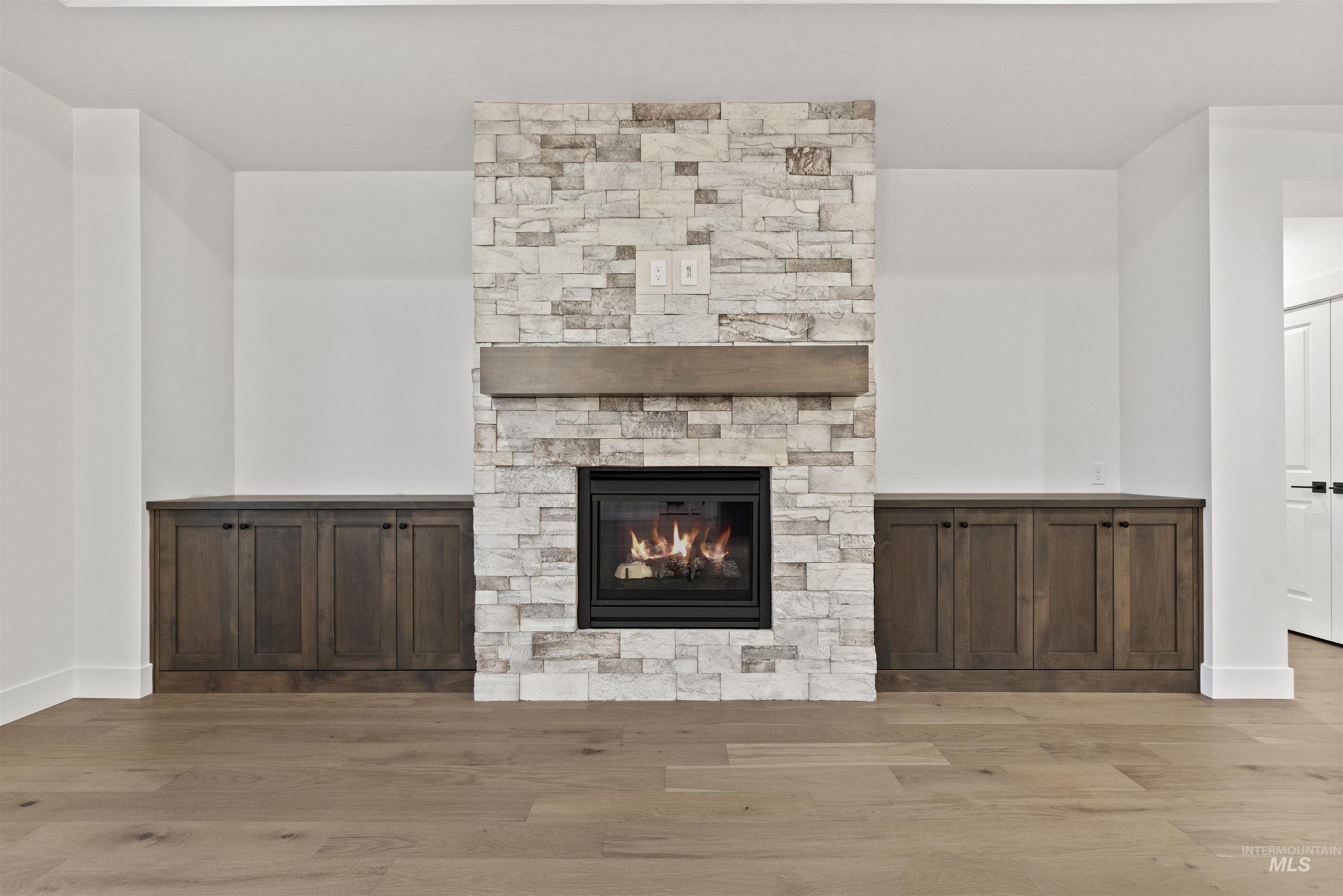 2129 East Blakehurst Street Kuna, ID 83634 - Photo 6 of 34 Unfurnished living room with a fireplace and light wood-style flooring
