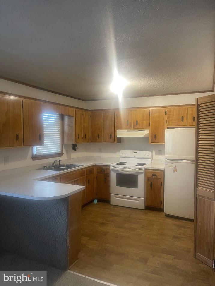 204 East Adams Street Georgetown, DE 19947 - Photo 13 of 18 a kitchen with a sink stove and refrigerator