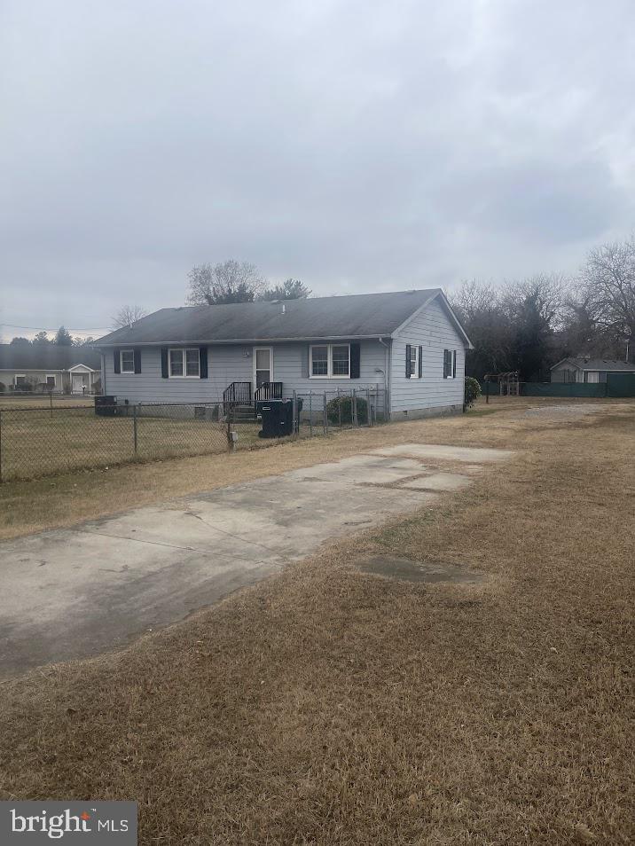 204 East Adams Street Georgetown, DE 19947 - Photo 7 of 18 a view of a big house with a big yard and large trees