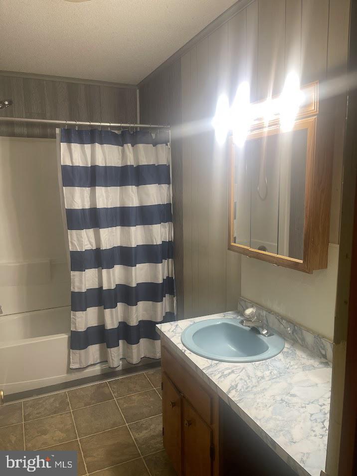 204 East Adams Street Georgetown, DE 19947 - Photo 9 of 18 a bathroom with a granite countertop sink and a mirror
