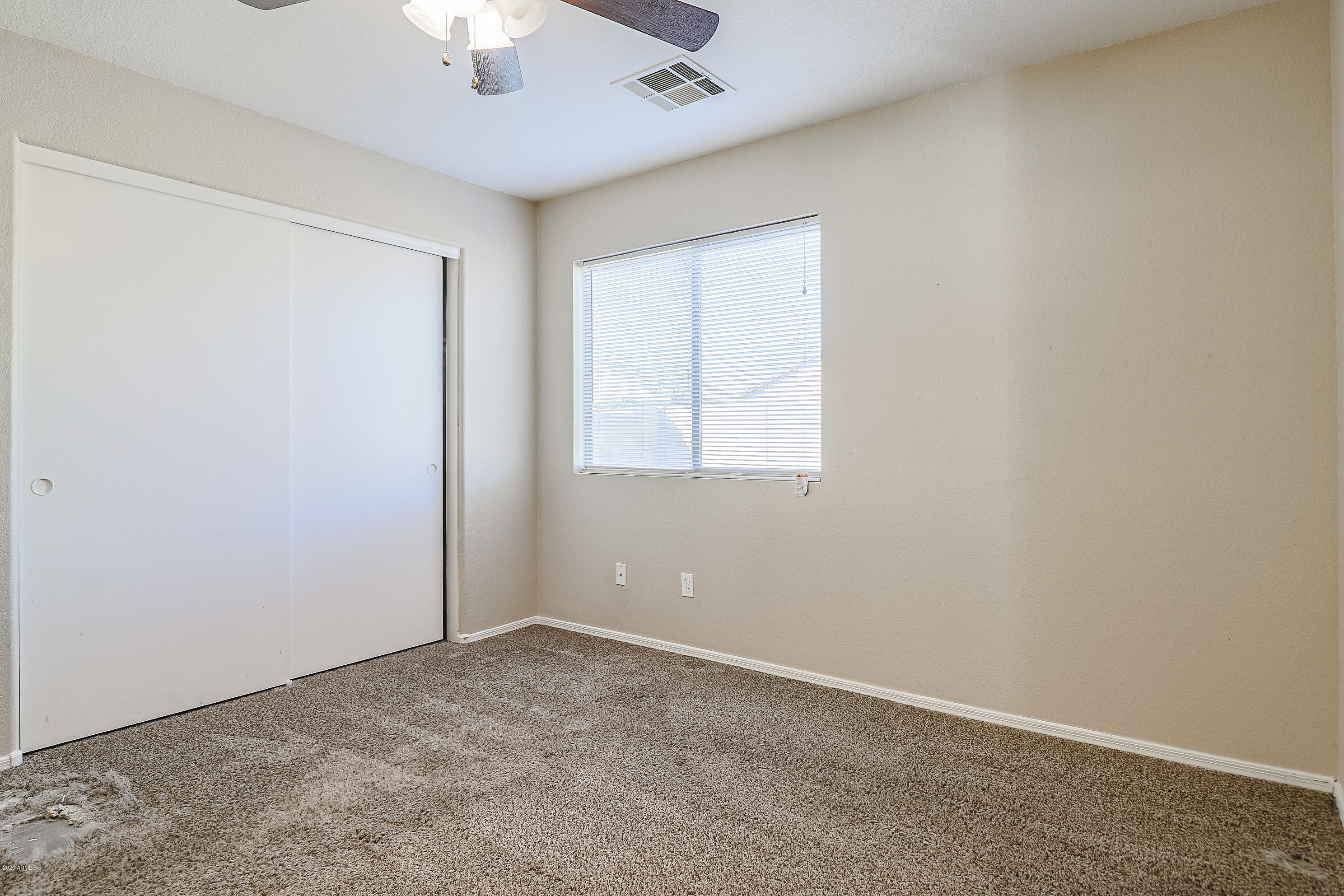 15038 West Redfield Road Surprise, AZ 85379 - Photo 15 of 21 an empty room with a window and a chandelier fan