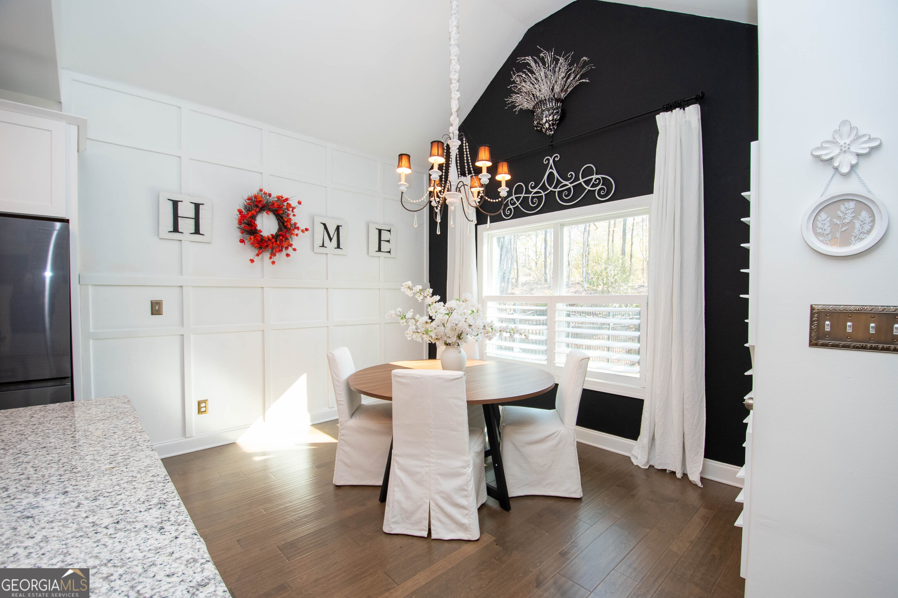6 Delaware Way Newnan, GA 30265 - Photo 14 of 42 a dining room with wooden floor a chandelier a wooden table and chairs