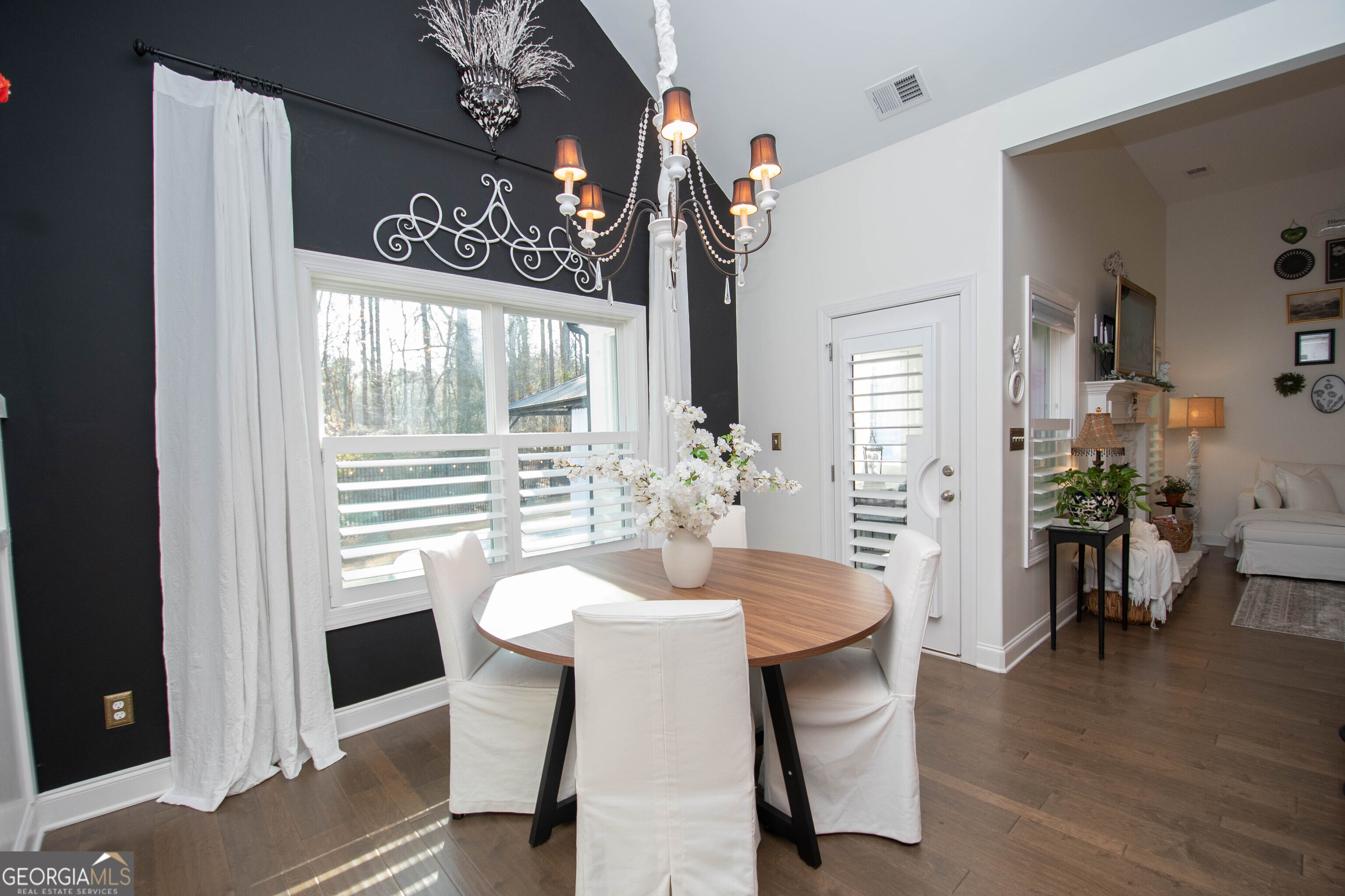 6 Delaware Way Newnan, GA 30265 - Photo 15 of 42 a dining room with furniture potted plants and wooden floor