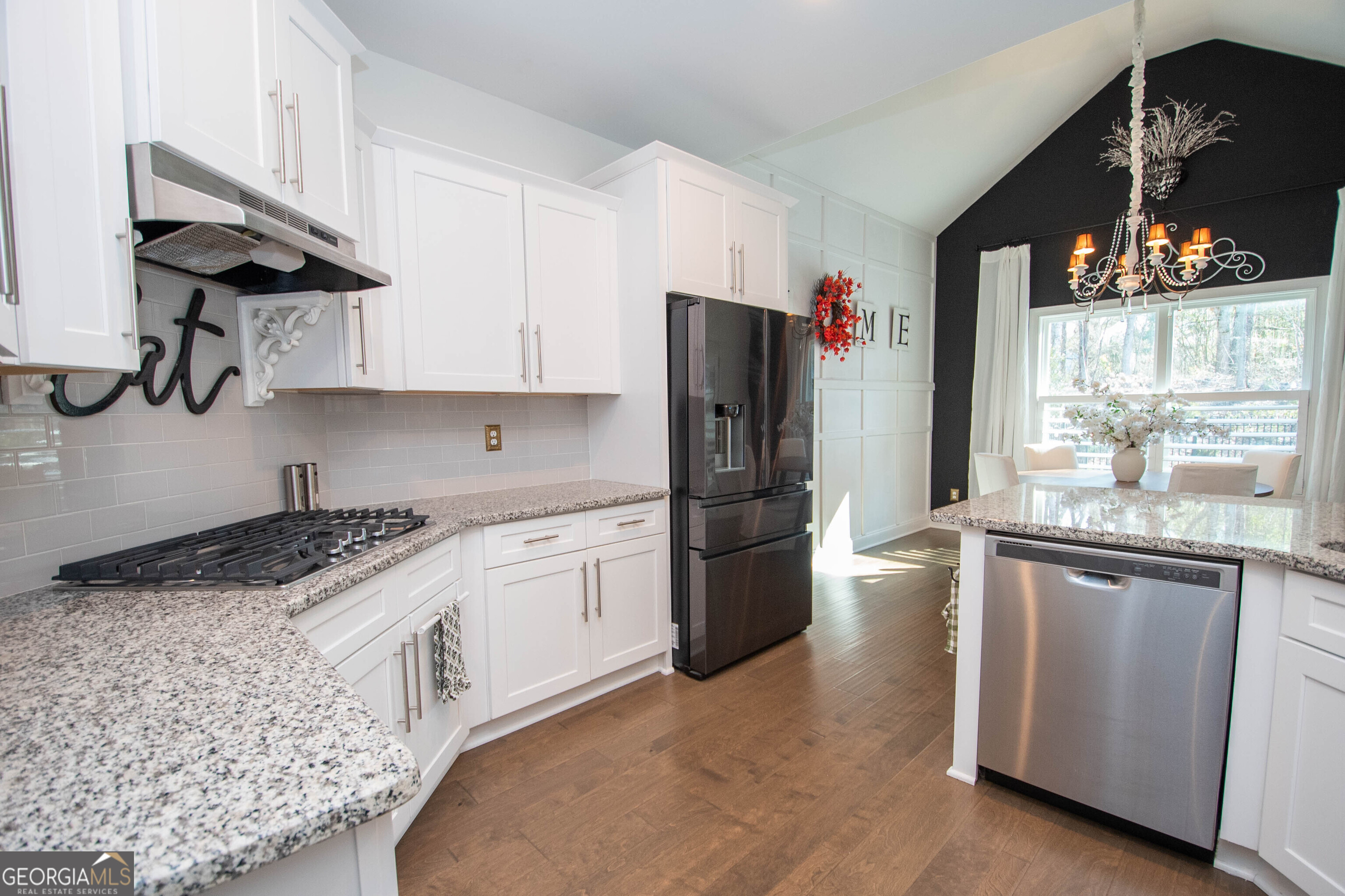 6 Delaware Way Newnan, GA 30265 - Photo 20 of 42 a kitchen with stainless steel appliances granite countertop a refrigerator a sink dishwasher a stove and white countertops with wooden floor
