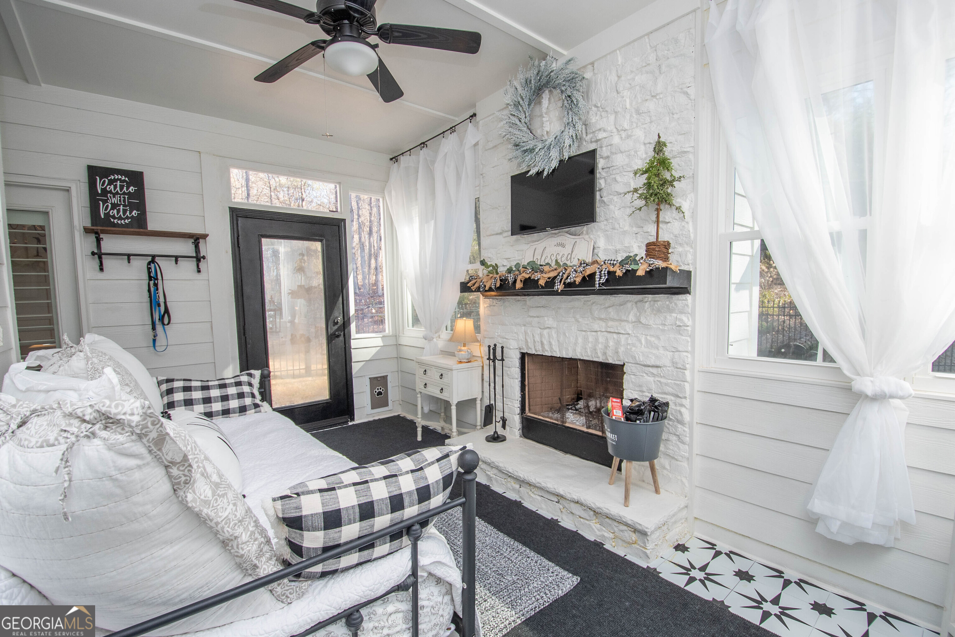 6 Delaware Way Newnan, GA 30265 - Photo 24 of 42 a living room with furniture a fireplace and a flat screen tv