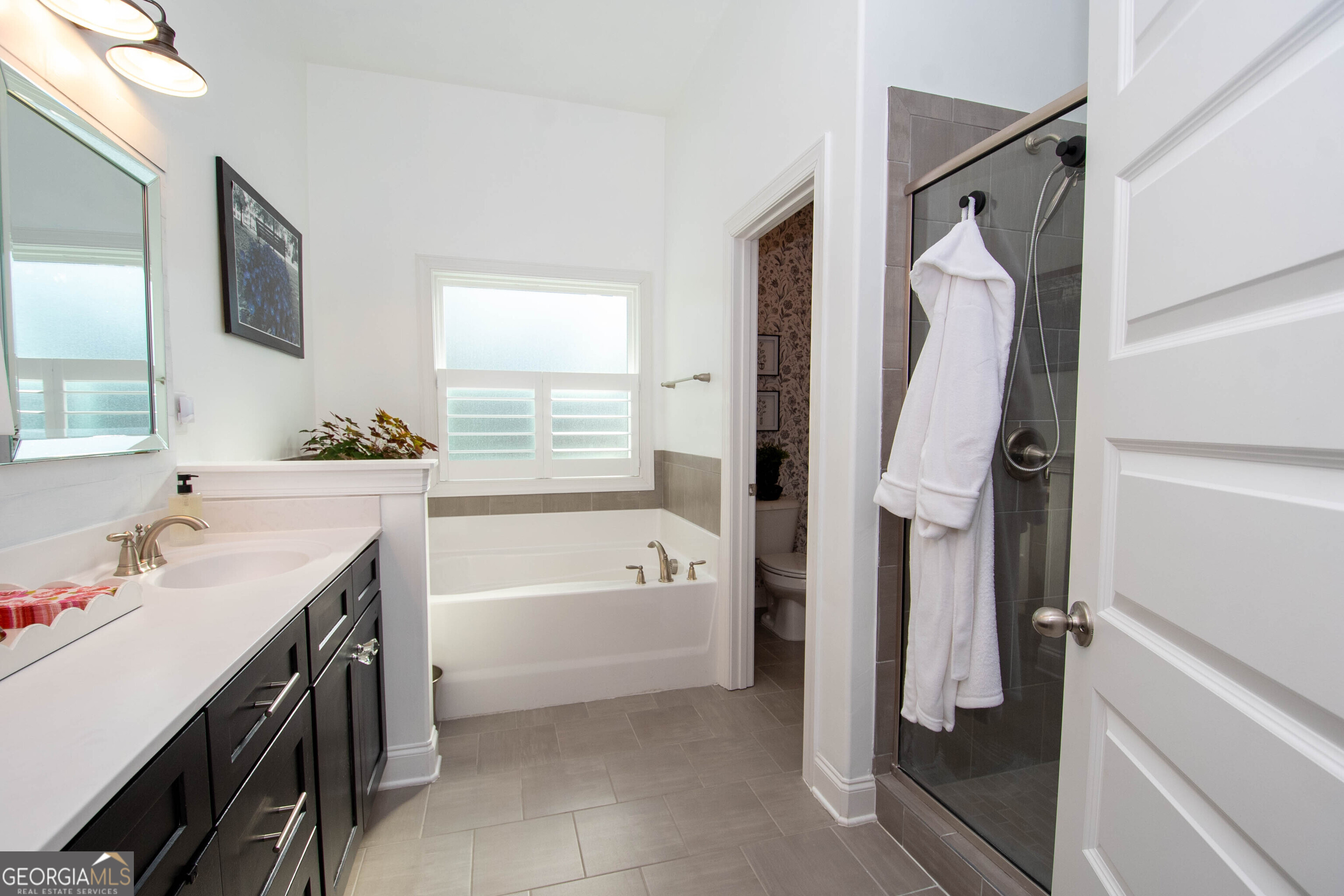 6 Delaware Way Newnan, GA 30265 - Photo 32 of 42 a bathroom with a tub sink and mirror