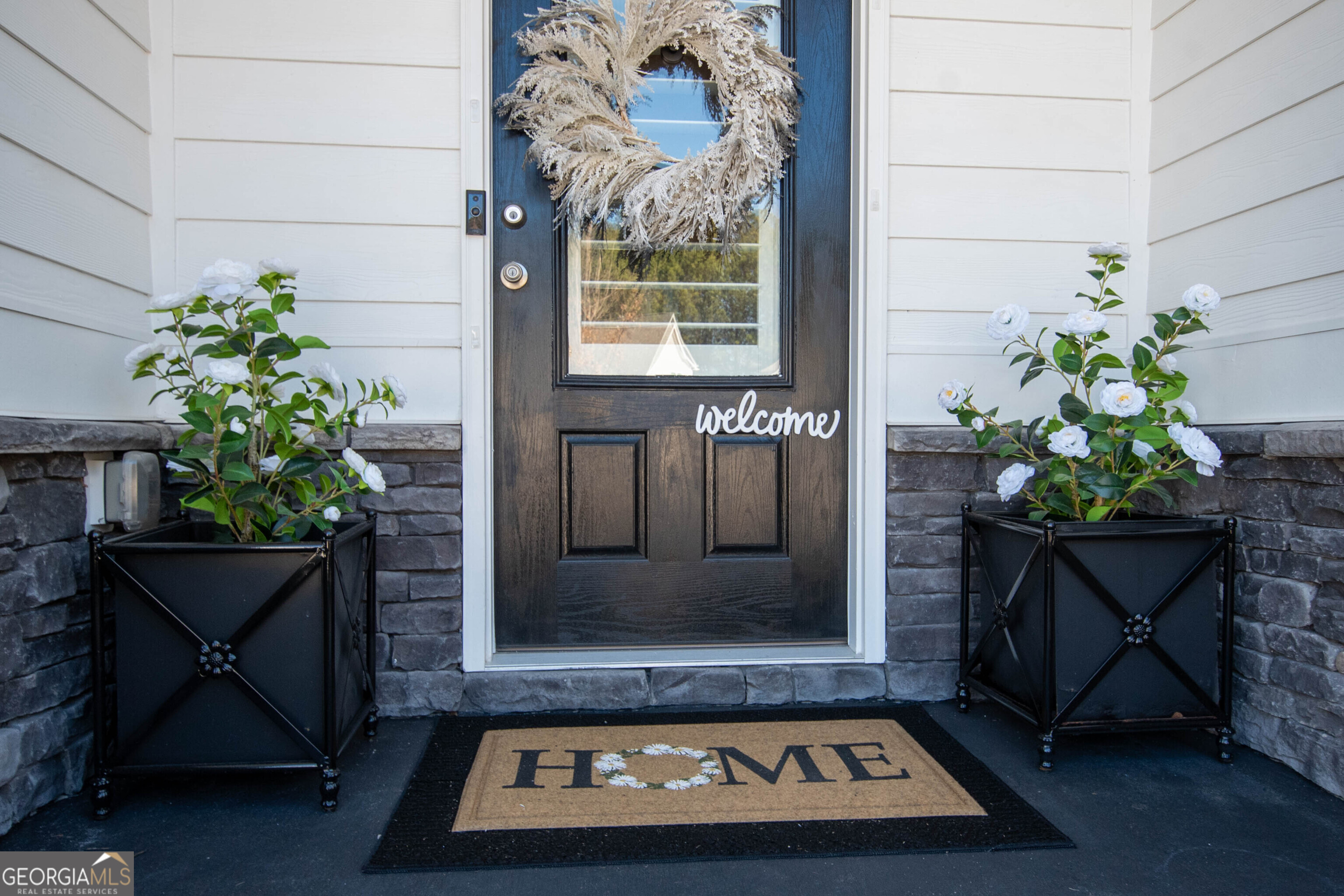 6 Delaware Way Newnan, GA 30265 - Photo 5 of 42 a view of a entryway door with plants