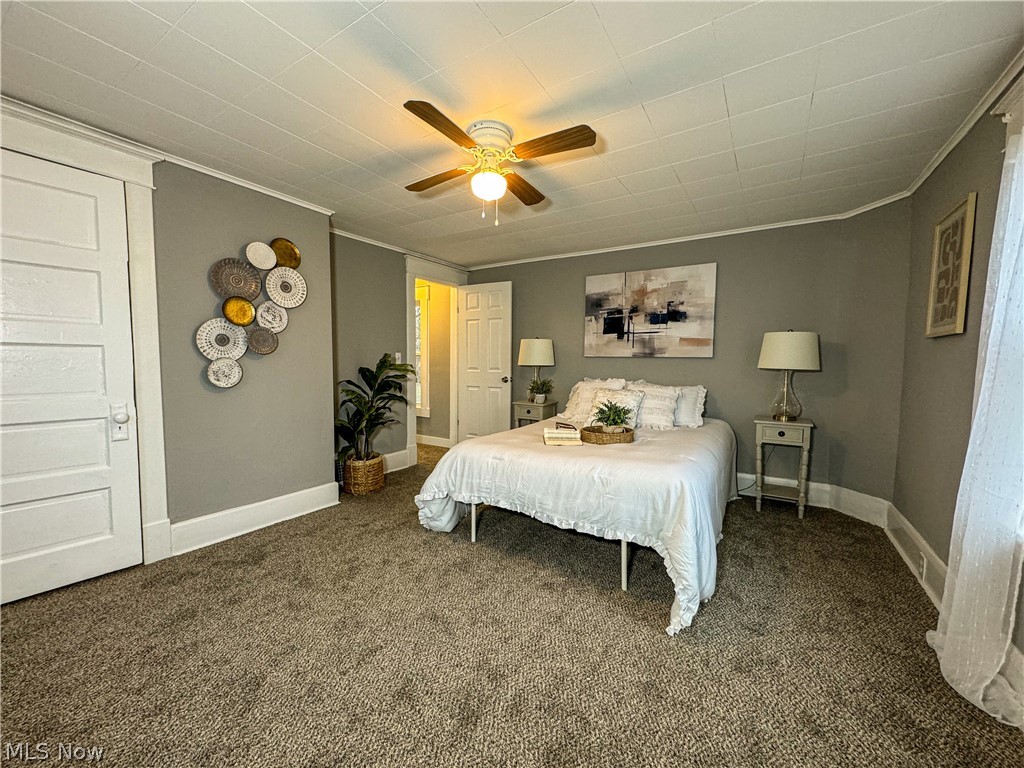 306 Robinson Road Campbell, OH 44405 - Photo 13 of 21 Bedroom featuring dark colored carpet, crown molding, and ceiling fan