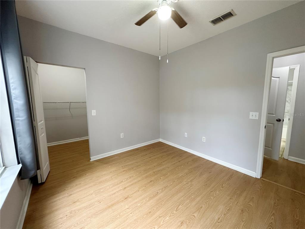 12843 Madison Pointe Circle, Unit 201 Orlando, FL 32821 - Photo 11 of 53 an empty room with wooden floor and entrance