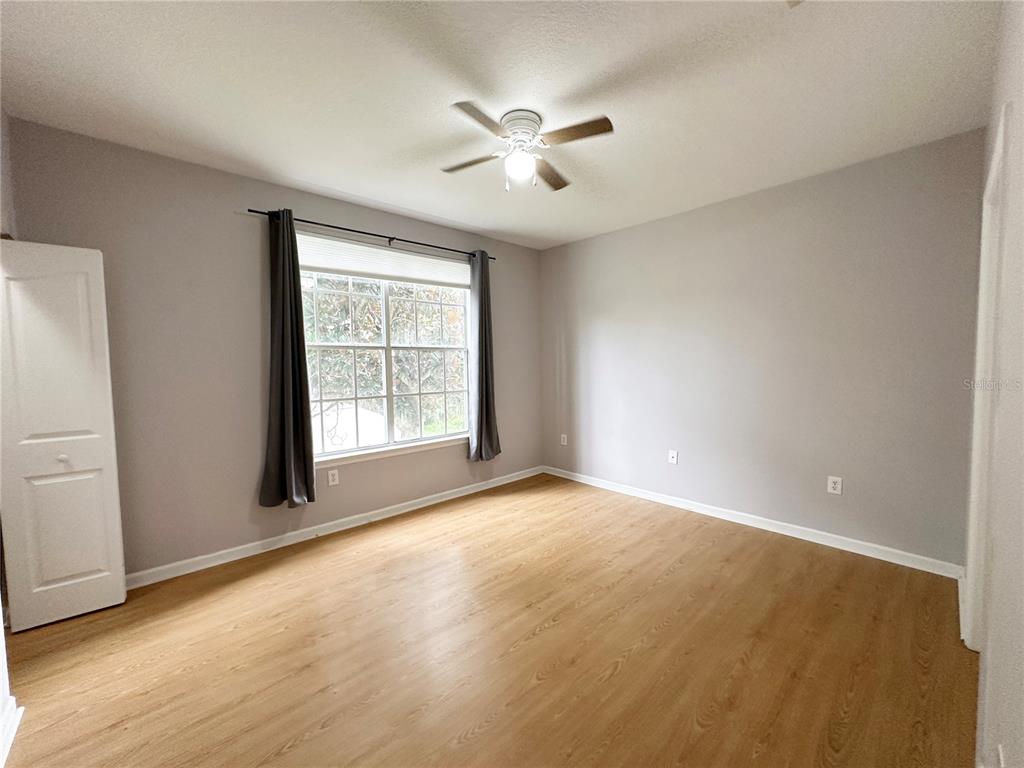 12843 Madison Pointe Circle, Unit 201 Orlando, FL 32821 - Photo 13 of 53 a view of an empty room with a window