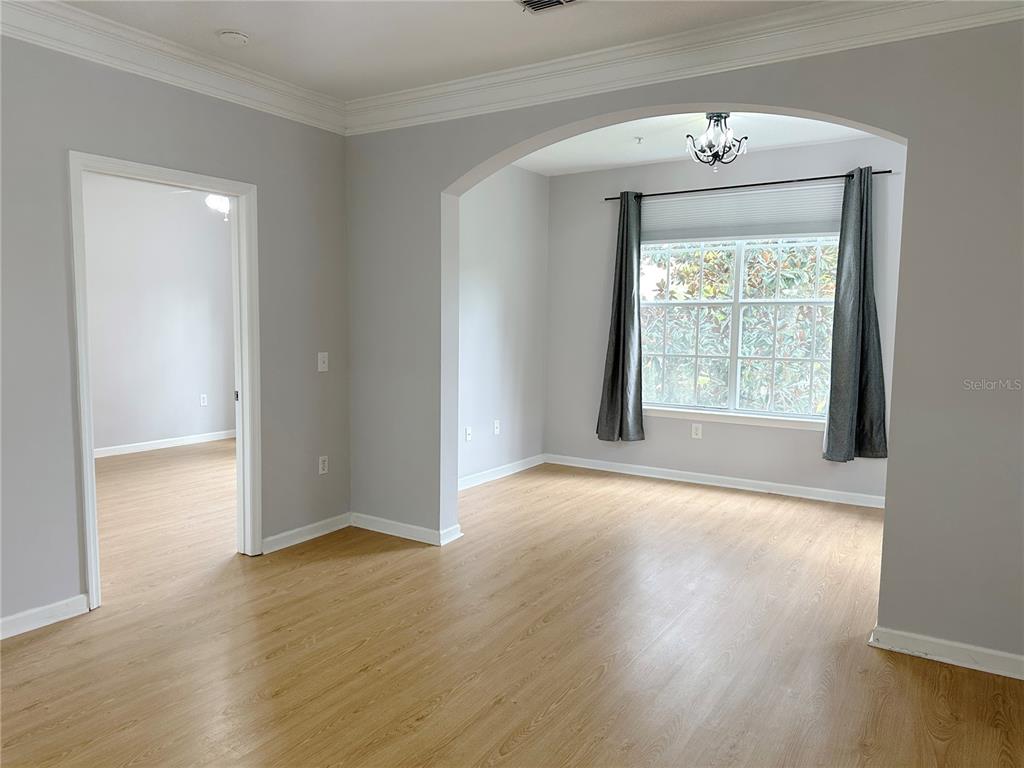 12843 Madison Pointe Circle, Unit 201 Orlando, FL 32821 - Photo 17 of 53 a view of an empty room with wooden floor and a window