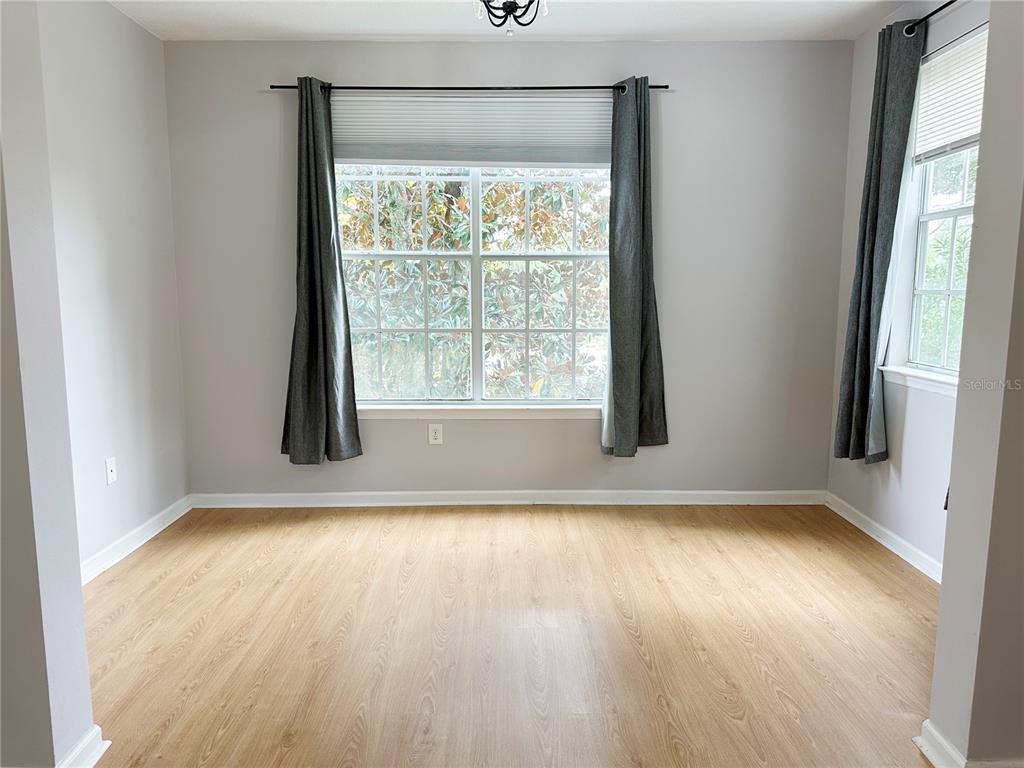 12843 Madison Pointe Circle, Unit 201 Orlando, FL 32821 - Photo 18 of 53 an empty room with wooden floor and windows