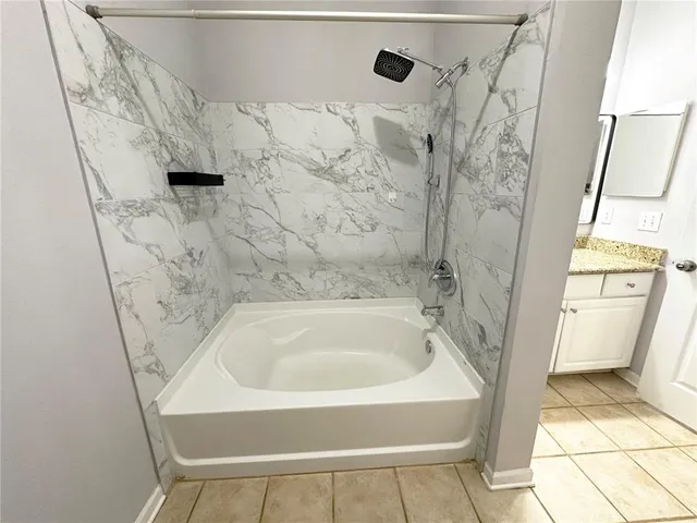 a bathroom with a tub and shower
