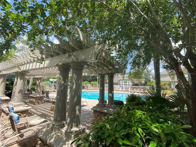 a tree in a yard next to a building