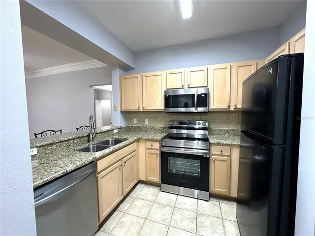 a kitchen with a sink stove and refrigerator
