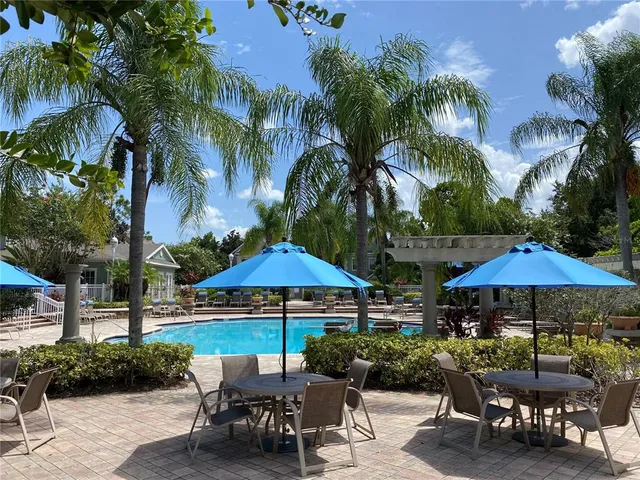 a view of a patio with table and chairs under an umbrella