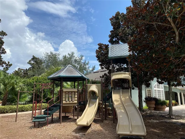 a view of a wooden bench sitting in backyard of house