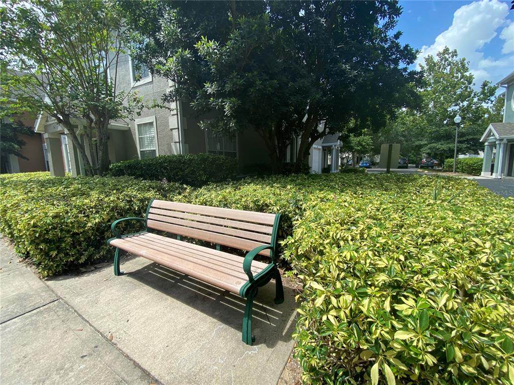 12843 Madison Pointe Circle, Unit 201 Orlando, FL 32821 - Photo 39 of 53 a view of a wooden bench sitting in backyard of house