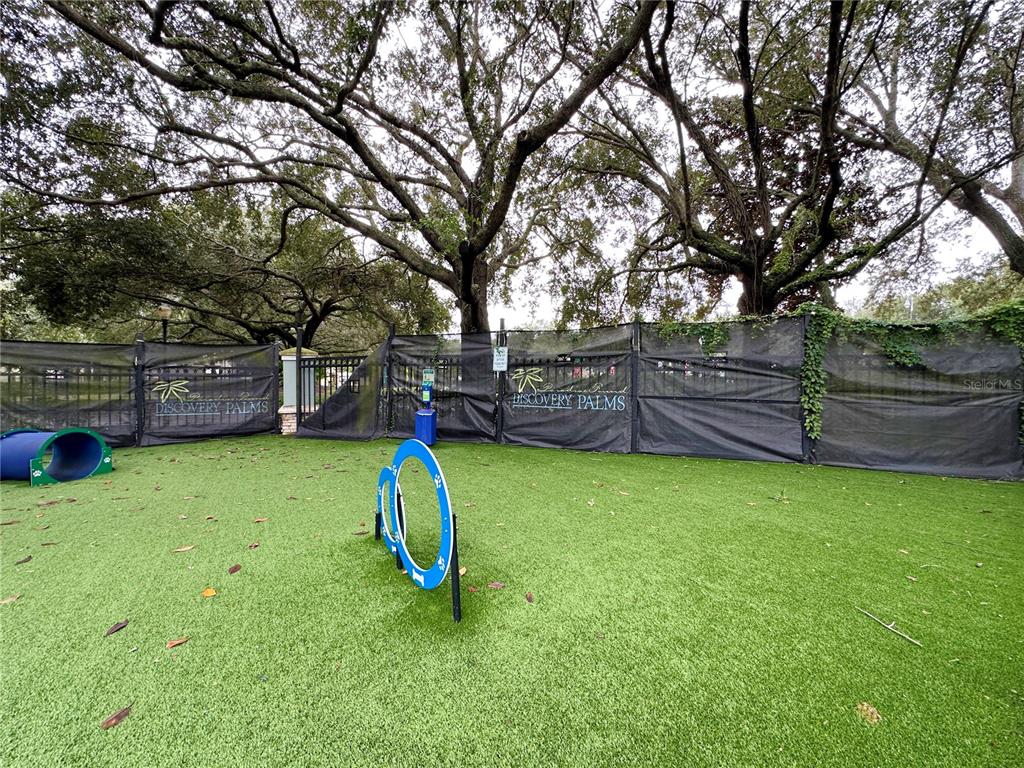 12843 Madison Pointe Circle, Unit 201 Orlando, FL 32821 - Photo 48 of 53 a view of a backyard with a slide