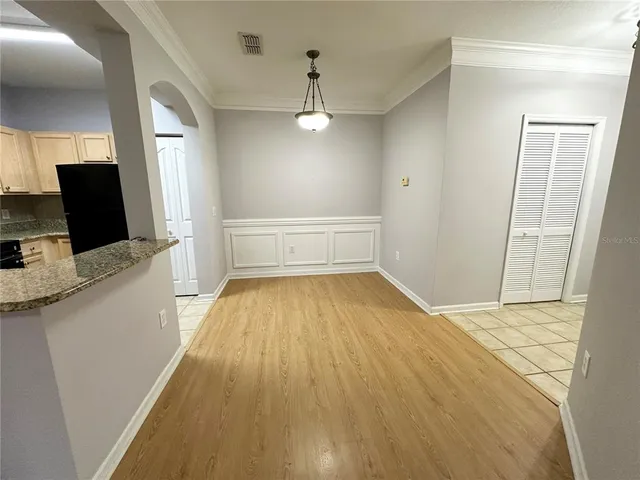a view of a room with wooden floor and staircase