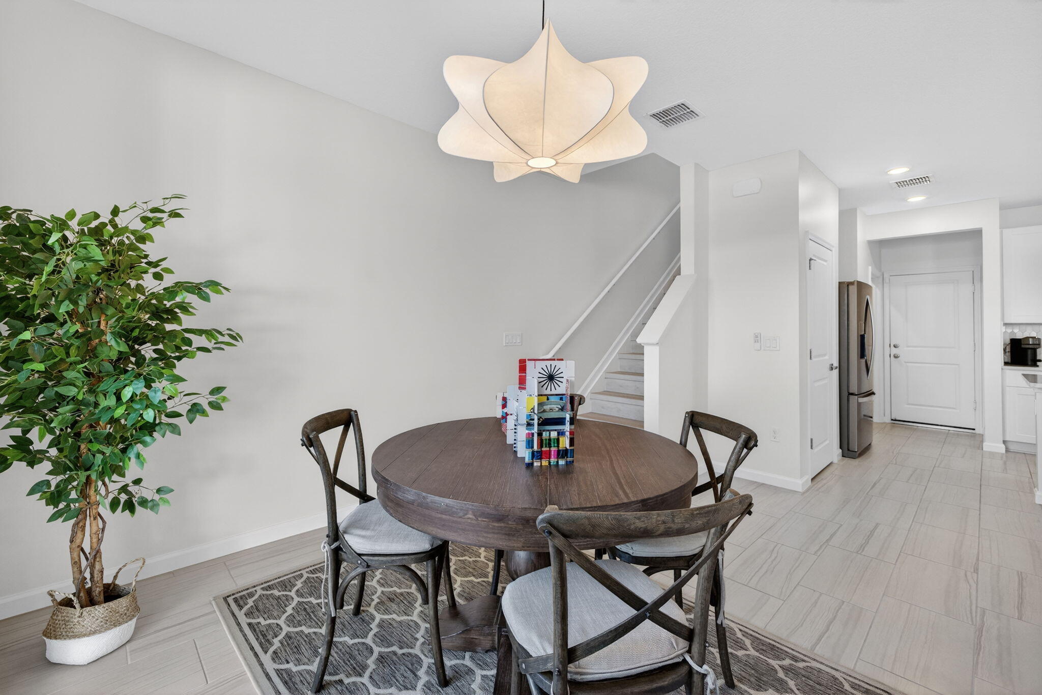 5624 Southeast Edgewater Circle Stuart, FL 34997 - Photo 12 of 33 a view of a dining room with furniture and wooden floor