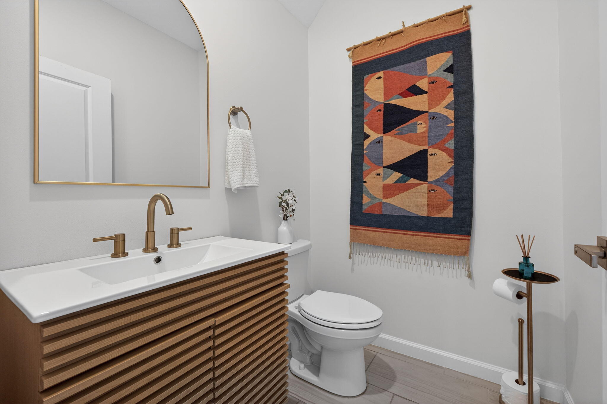 5624 Southeast Edgewater Circle Stuart, FL 34997 - Photo 14 of 33 a bathroom with a sink a toilet and mirror