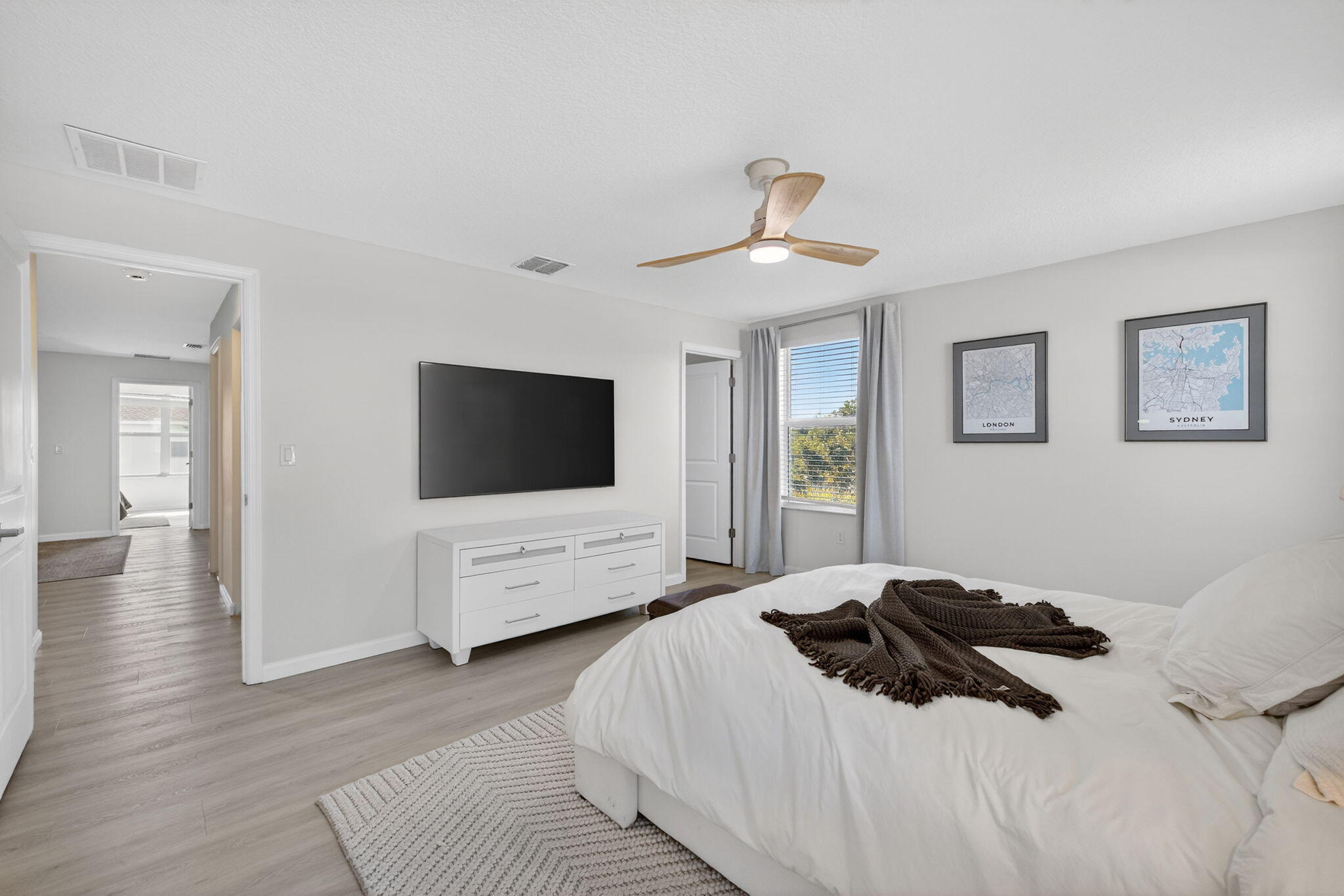 5624 Southeast Edgewater Circle Stuart, FL 34997 - Photo 17 of 33 a bedroom with a large bed and a flat screen tv