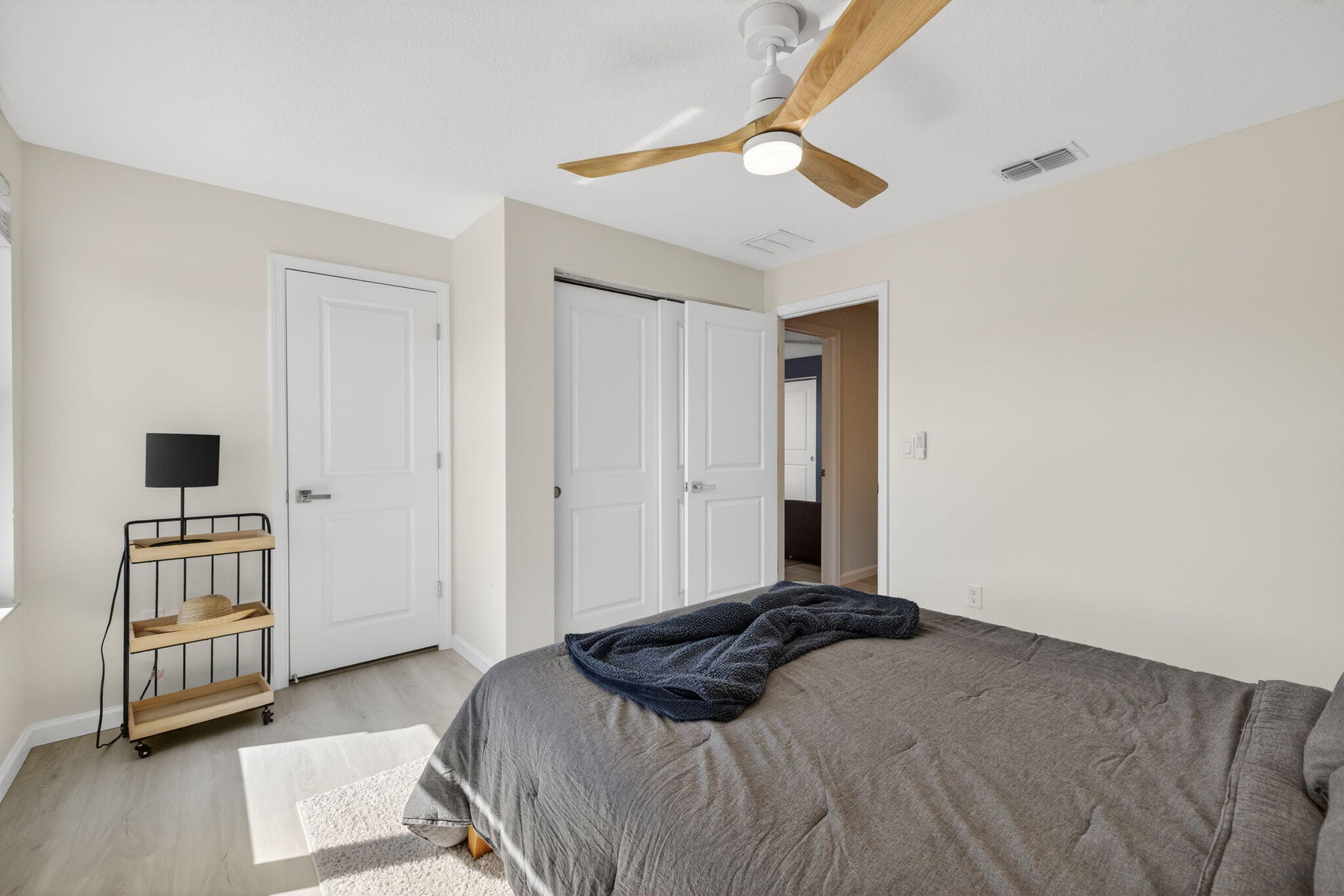 5624 Southeast Edgewater Circle Stuart, FL 34997 - Photo 21 of 33 a bedroom with a bed and a chandelier