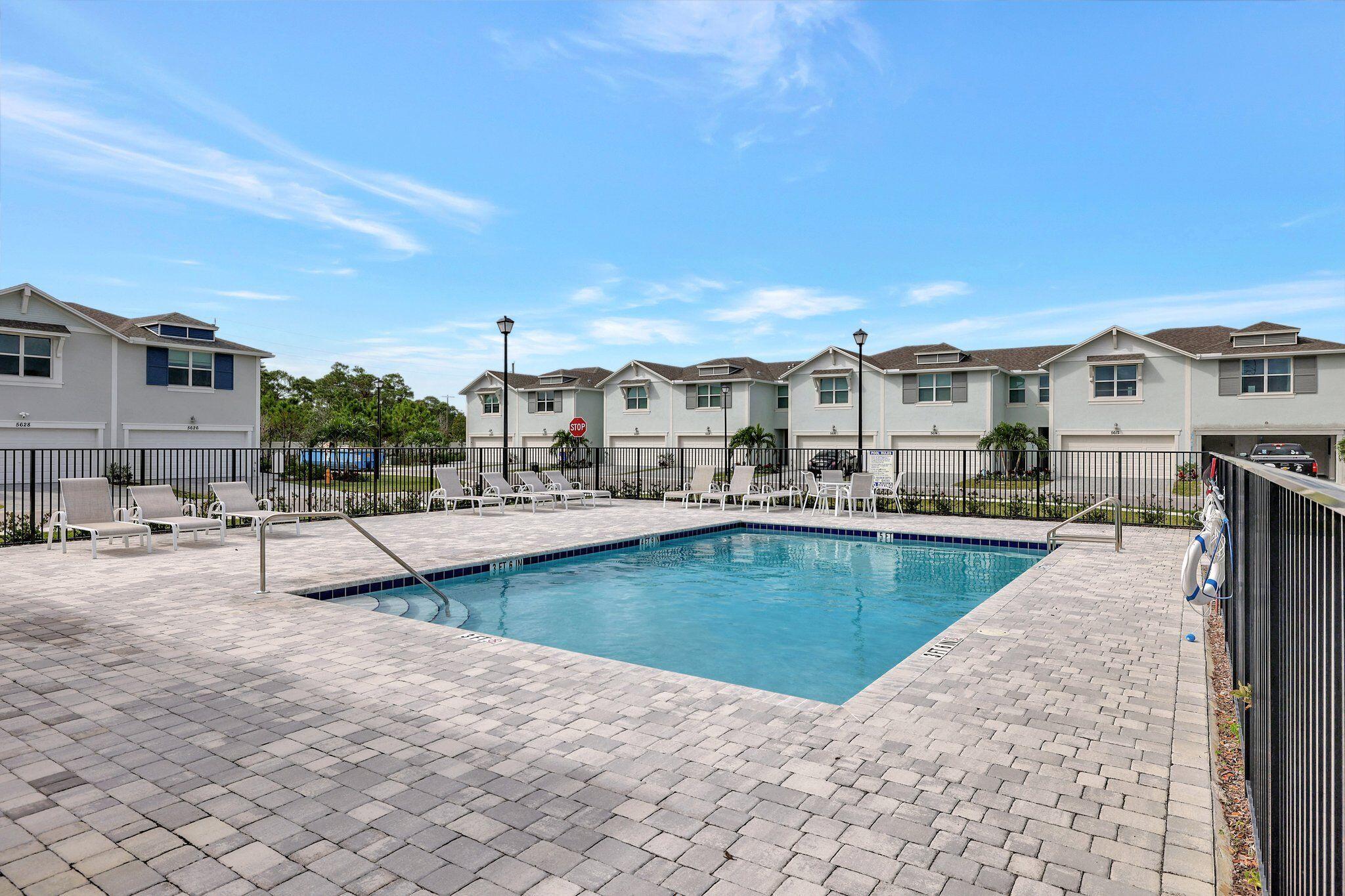 5624 Southeast Edgewater Circle Stuart, FL 34997 - Photo 32 of 33 a view of a swimming pool and lounge chair