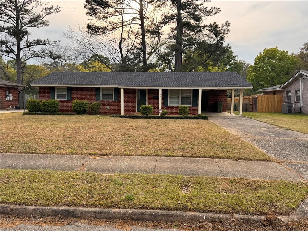 814 Avondale Road Montgomery, AL 36109 - Photo 1 of 10 Ranch-style house featuring an attached carport, concrete driveway, covered porch, and brick siding