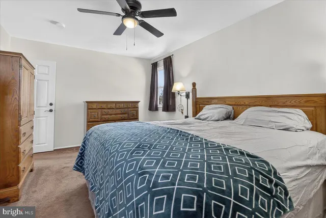 a spacious bedroom with a bed and window