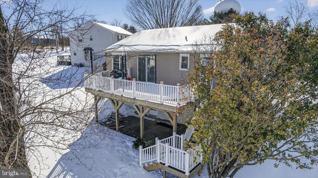 a view of a balcony with chairs and wooden floor