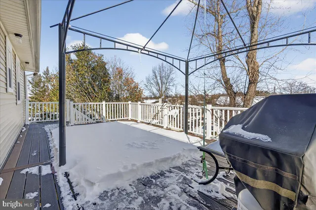 a view of a large white house with a snow