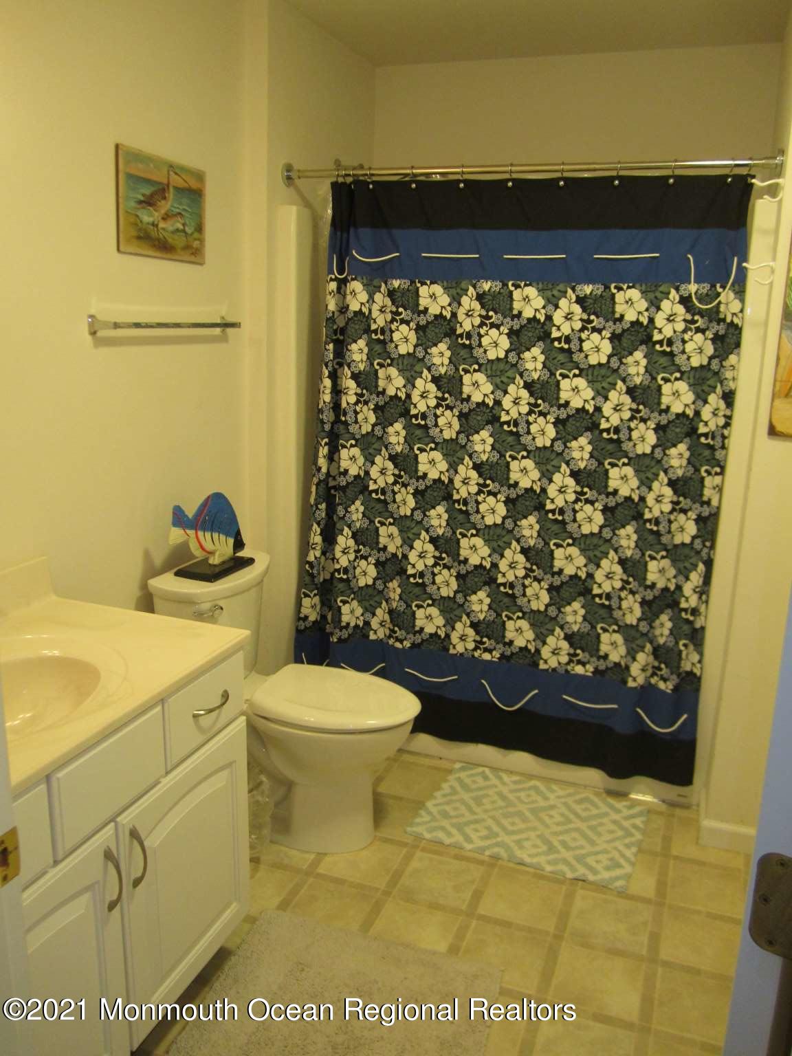 111 Marlin Road Tuckerton, NJ 08087 - Photo 13 of 23 a bathroom with a toilet and a shower curtain