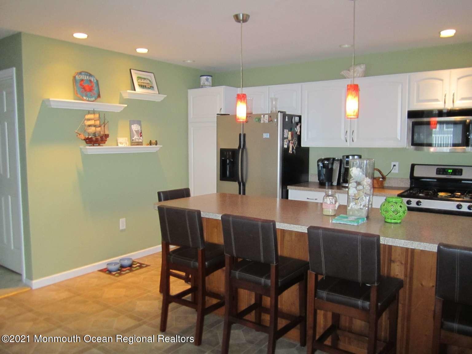 111 Marlin Road Tuckerton, NJ 08087 - Photo 5 of 23 a kitchen with stainless steel appliances dining table and chairs