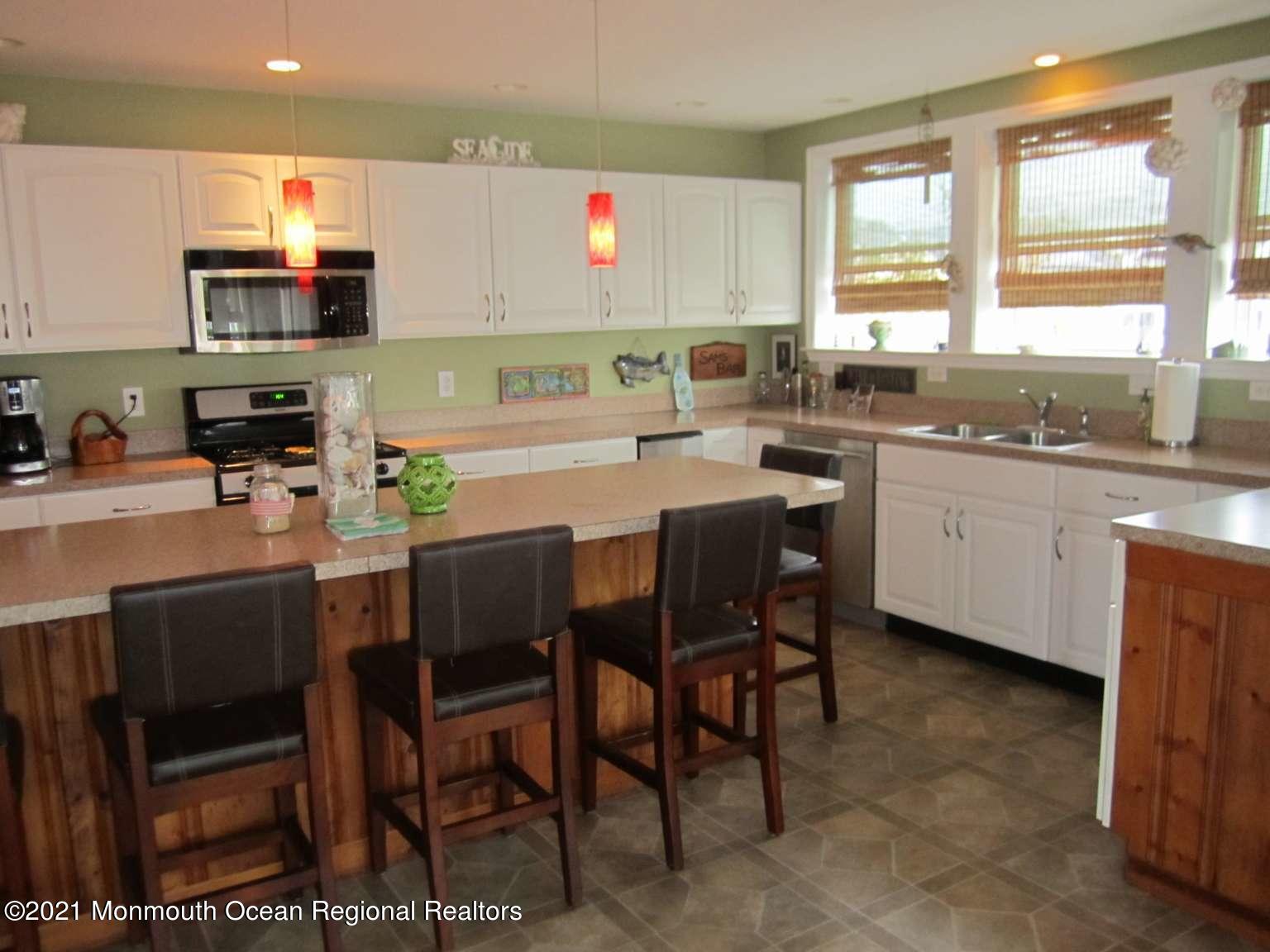 111 Marlin Road Tuckerton, NJ 08087 - Photo 6 of 23 a kitchen with a table chairs sink and cabinets