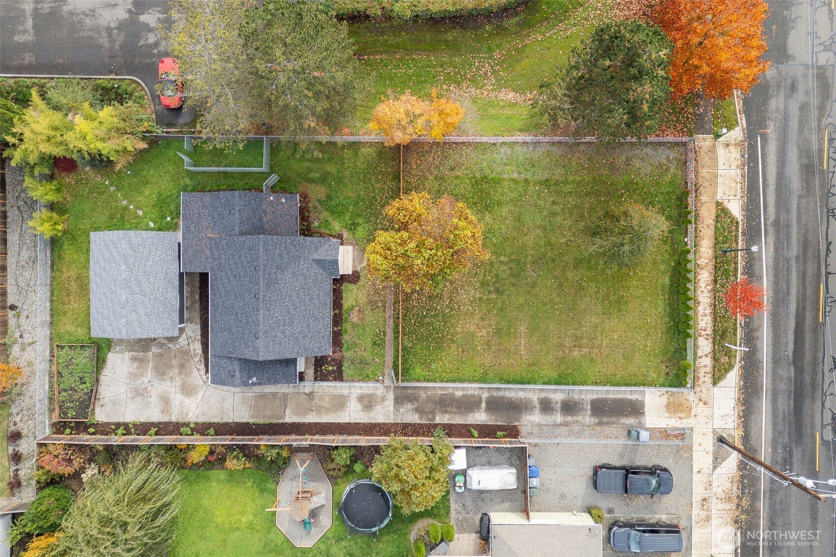 5703 Parker Road East, Unit 1 Sumner, WA 98390 - Photo 7 of 10 an aerial view of residential houses with outdoor space and swimming pool