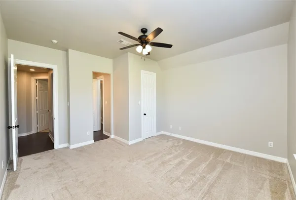 an empty room with a ceiling fan and a ceiling fan