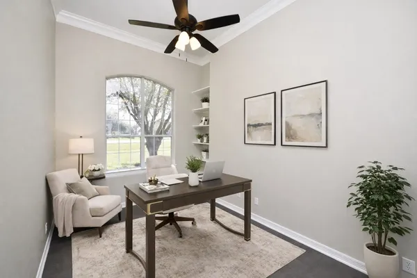 a view of an empty room with a fireplace and a window