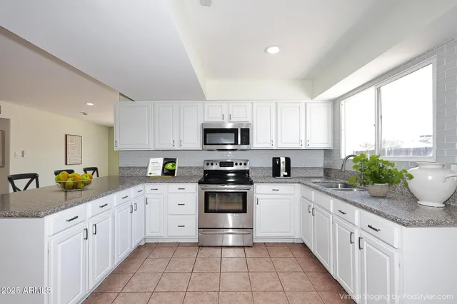 a kitchen with stainless steel appliances a stove sink microwave and cabinets