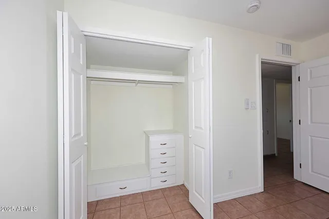 a view of walk in closet with cabinet