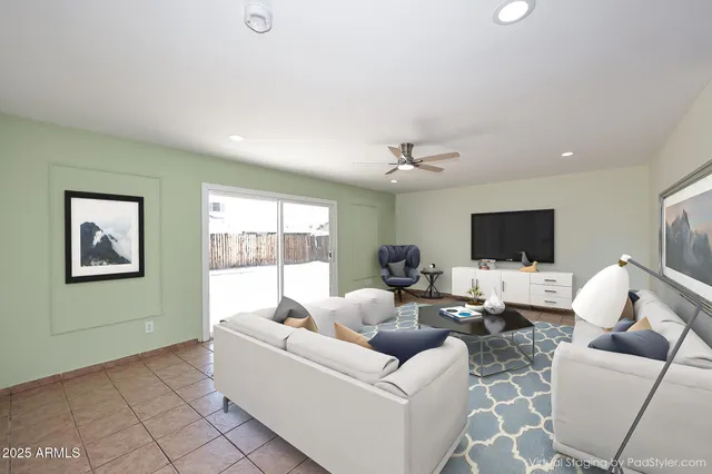a living room with furniture and a flat screen tv