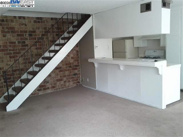 Undisclosed Address Pleasanton, CA 94588 - Photo 3 of 17 a view of kitchen with stairs and wooden floor