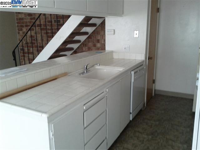 Undisclosed Address Pleasanton, CA 94588 - Photo 4 of 17 a kitchen with a sink and a washer dryer