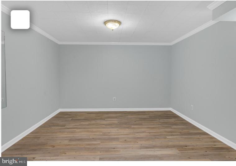 6701 Furman Parkway Riverdale, MD 20737 - Photo 2 of 9 a view of an empty room with wooden floor and a window