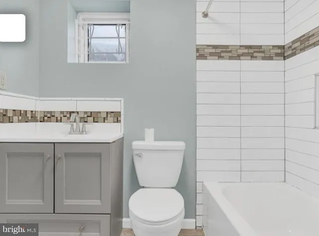 a bathroom with a toilet and a sink