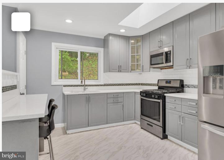 6701 Furman Parkway Riverdale, MD 20737 - Photo 7 of 9 a kitchen with a sink stove and microwave