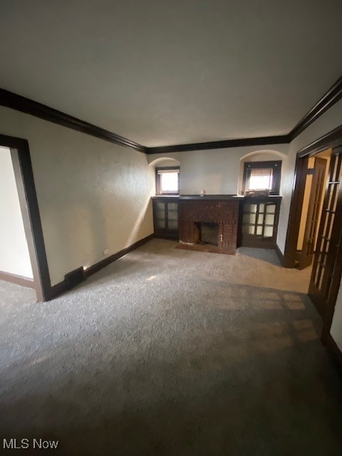 1843 Reyburn Road Cleveland, OH 44112 - Photo 10 of 39 Unfurnished living room featuring carpet, ornamental molding, and a fireplace