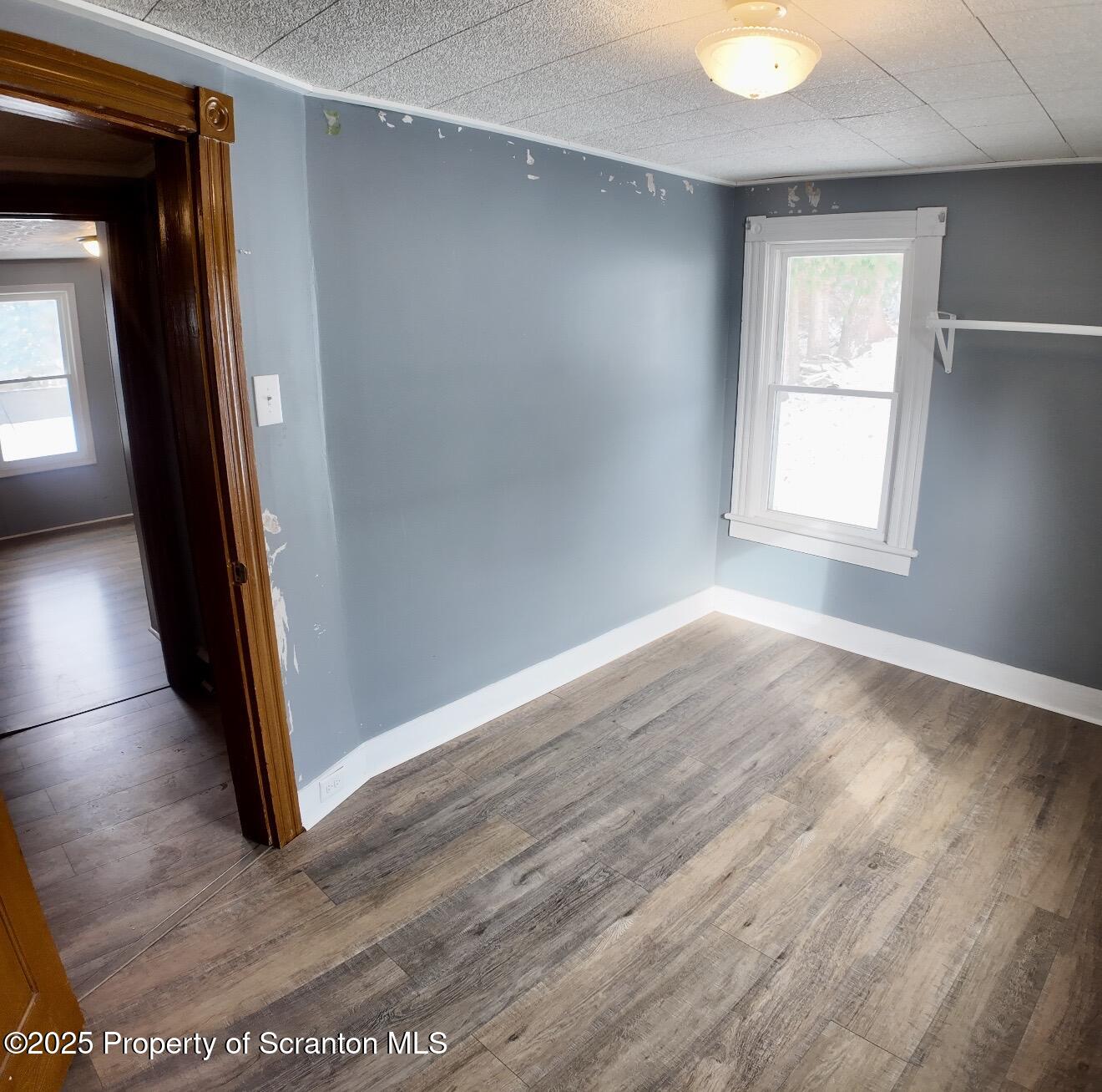 58 Owego Street Simpson, PA 18407 - Photo 15 of 16 an empty room with wooden floor and windows
