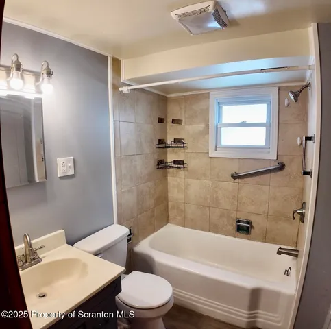 a bathroom with a toilet a sink and bathtub